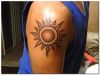 tribal sun tattoo on arm